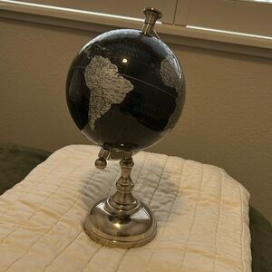Elegant desk globe with colors of silver, black and white. Approx 12 inches tall